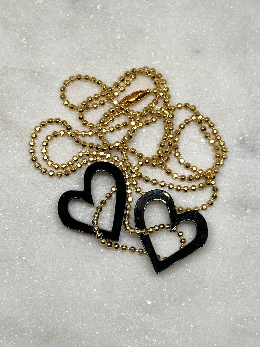 Necklace with black dangling hearts